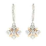 A pair of two-tone 14K gold stud earrings featuring white and rose gold with diamond accents.