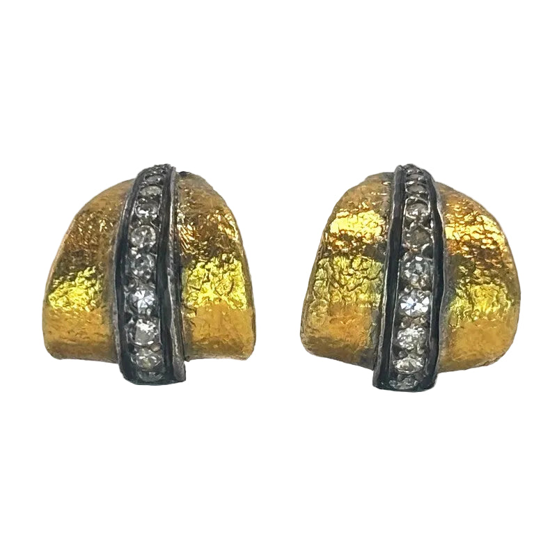A pair of gold dome-shaped earrings with a textured finish, featuring a central channel set with clear round stones on a white background.