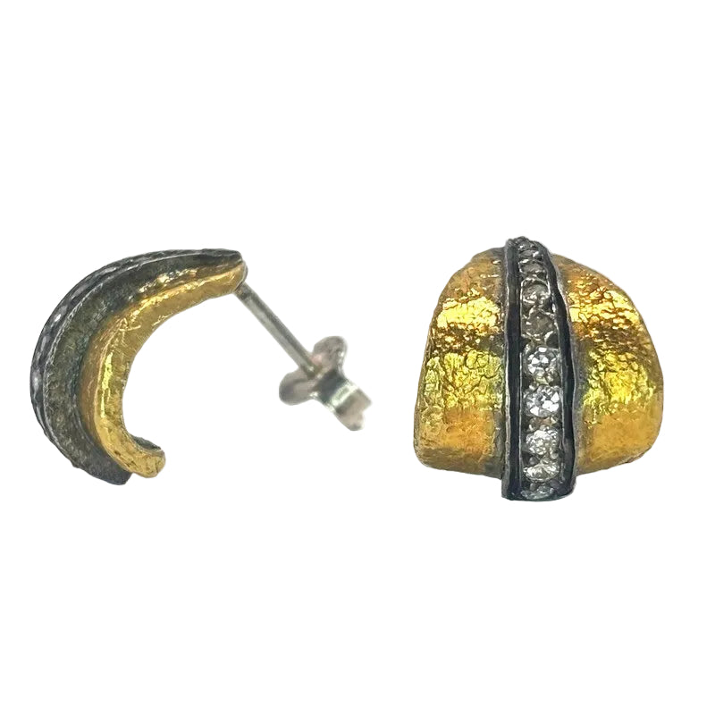 A pair of textured gold crescent moon stud earrings with a vertical band of clear pavé-set round stones on one earring, shown on a white background.