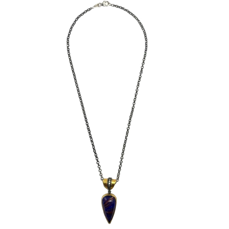 A dark gunmetal chain necklace with a gold-toned accent and a teardrop-shaped dark blue lapis lazuli pendant, shown against a plain white background.