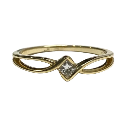A 10k yellow gold ring with a princess cut diamond in the center, set in a gold band.