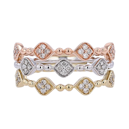 A tri-color diamond and 10k gold ring with multiple diamond accents on a gold band, displayed on a white background.